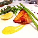 Smoked salmon steak cooked in the tandoor, with spiced baby asparagus and arugula salad.