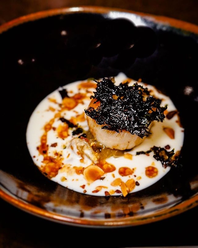 On a bed of cooked-soft onions and peppers, lay this Scallop with Ajoblanco, a cold soup of garlic and almonds ($17++).