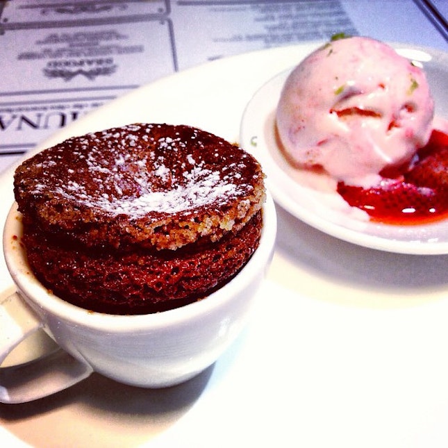 Hot Chocolate Soufflé with Strawberry Ice Cream.
