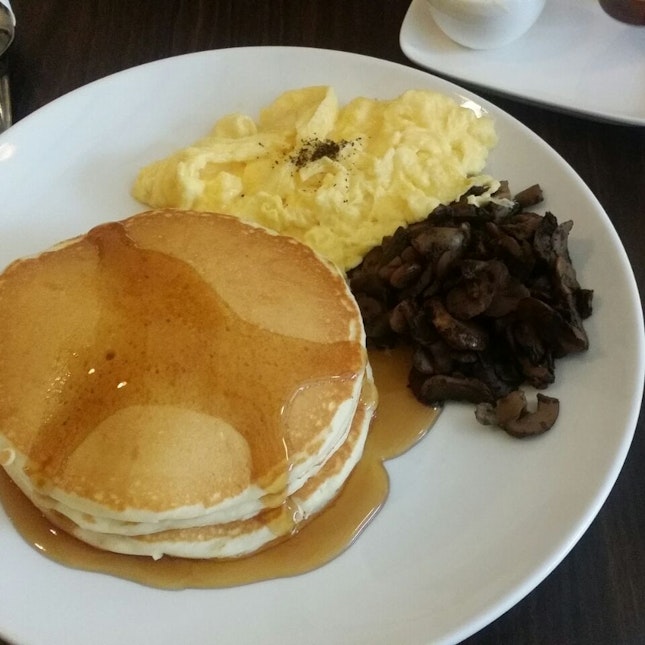 Pancakes with scrambled eggs and sauté mushrooms
