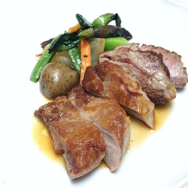 Pluma Iberica, a deliciously fatty cut of a pig's shoulder, served with a side of greens.