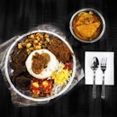 Nasi Ambeng is a communal style of a family meal where rice and other savoury dishes are nicely placed on a huge platter. 