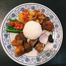 A hearty plate of Nasi Campur, replete with prawns, mutton, chicken, tofu, fish and a spicy dose of sambal belacan!