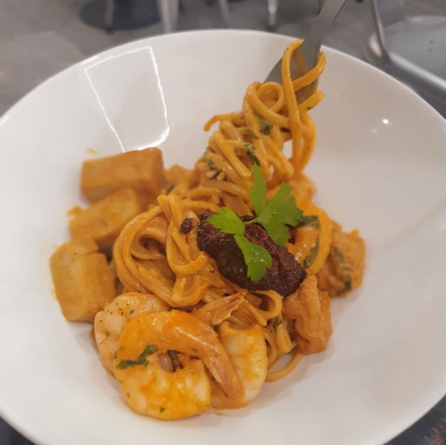 Halal fusion pastas at an industrial grey-themed cafe 