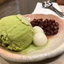 Matcha ice cream served with azuki red beans and mochi.