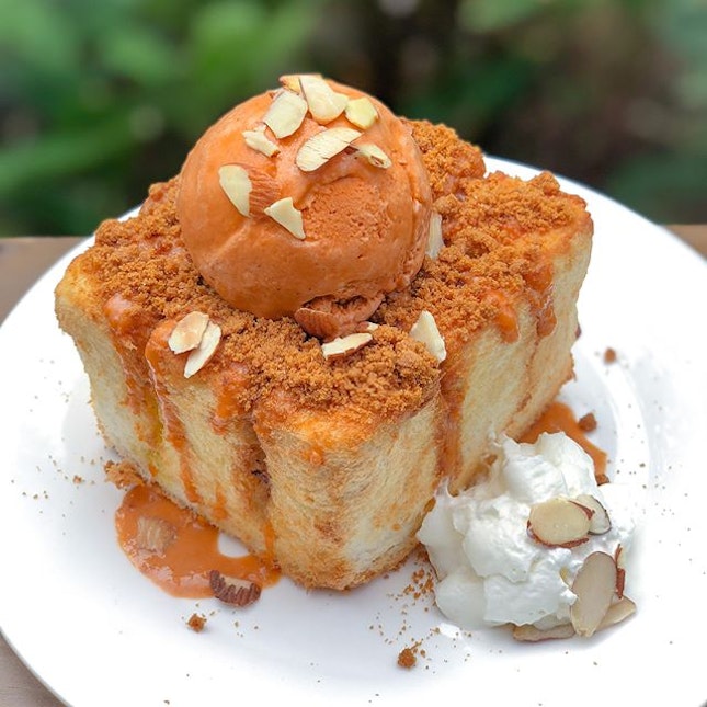 Thai milk tea shibuya toast [$9.90] Served with a scoop of Thai milk tea ice cream and garnished with crushed almond flakes, the thick shibuya toast is drizzled with Thai milk tea sauce and topped with cookie crumbs.