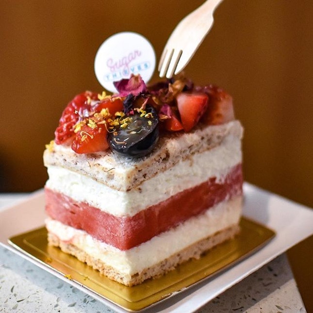 Strawberry watermelon cake [$8.90] Managed to be one of the lucky ones to grab the remaining last few slices left on their last day of operations for 2018!✌🏻Comprising of a wedge of fresh, juicy and sweet watermelon sandwiched within two thick layers of rose-scented light pastry cream along with light and fluffy dacquoise-alike layers, the cake is also topped with fresh strawberries and grapes.