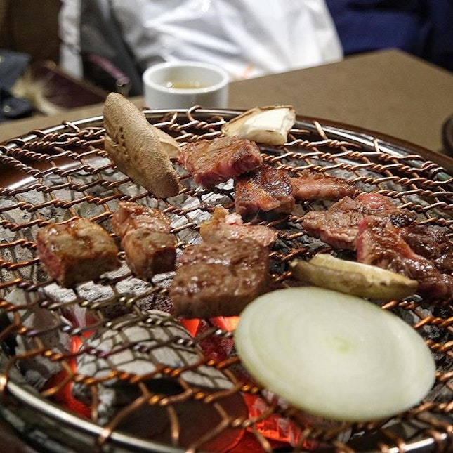 Simple yet succulent flavours of 한우 Korean beef, on a white charcoal grill.