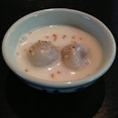 Kanin Dtom: Warm coconut rice dumplings served in salted coconut cream.