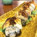 Sanshoku aburi roll topped with salmon, scallop and yellowtail.