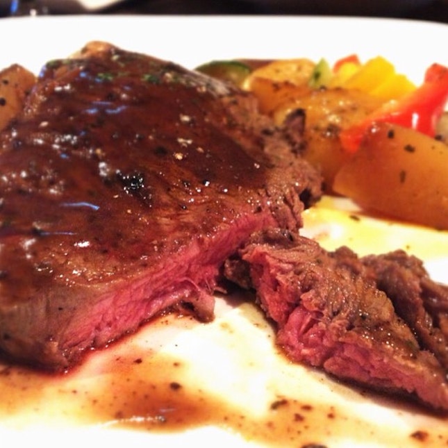 Sirloin steak, medium rare with mixed vegetables and potatoes.
