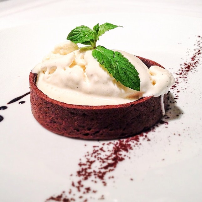 Oven baked dark chocolate tart with vanilla ice cream for dessert.