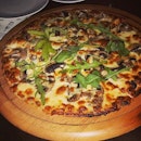 Very thin-crust mushroom and cheese pizza for nibbling on over buckets of Heineken and pints of Kronenbourg at Harry's.