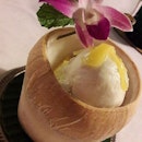 Classic Thai Coconut Ice-Cream (SGD$16.00) served in coconut husk and decorated with cempedek / jackfruit strips and fresh orchid flower.