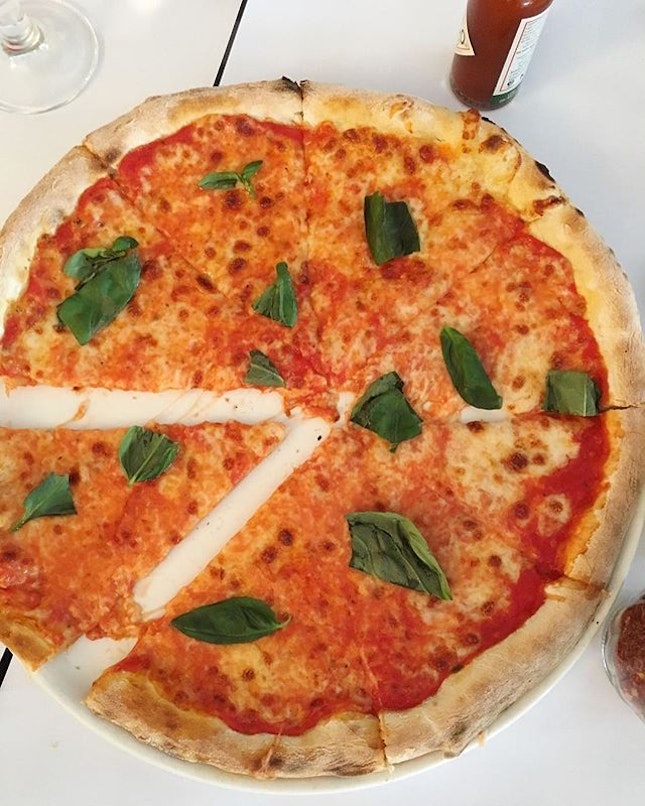 Pacman Pizza with a classic margherita, topped off with basil.