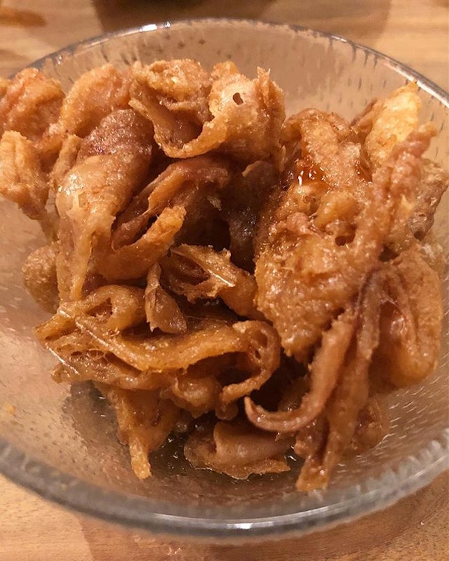 Deep fried chicken skins to be dipped with a grated radish sauce.
