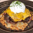 Salt beef hash, served with lots of caramelised onions and a poached egg on a bed of rosti