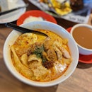 Laksa With Steamed Hainanese Chicken ($8.50).